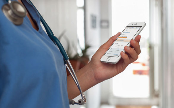 physician looking at moble online visit